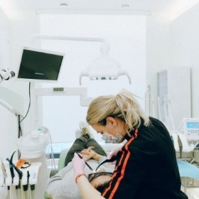 Dental team member treating dental patient