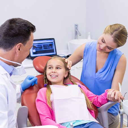 Mother child and dentist in dental office treatment room