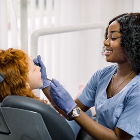 dentist working on child’s teeth   