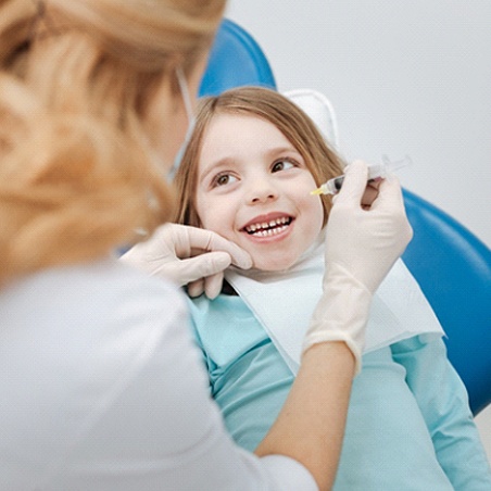 Dentist applying fluoride in Wylie