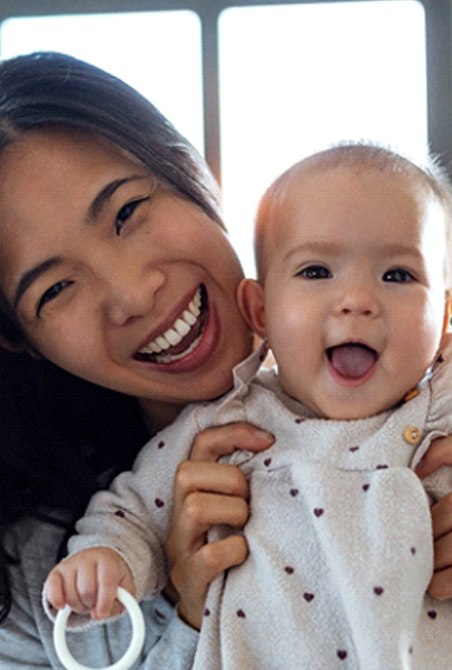 A mother and her baby laughing and smiling after visiting a pediatric dentist in Wylie