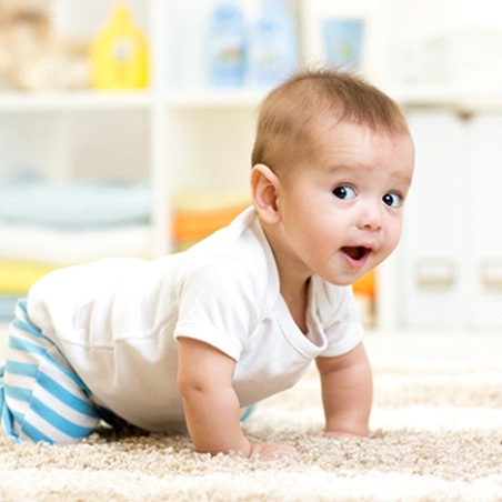 A happy baby crawling on the floor in Wylie
