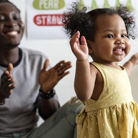 A father and his little girl laughing and playing after undergoing fluoride treatment in Wylie