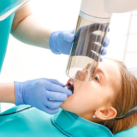 Dentist taking digital X-rays in Wylie