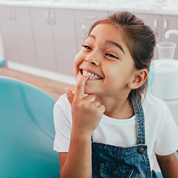 a child pointing at her healthy teeth in Wylie