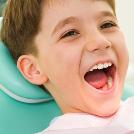 Young boy smiles after tooth extraction for kids in Wylie 