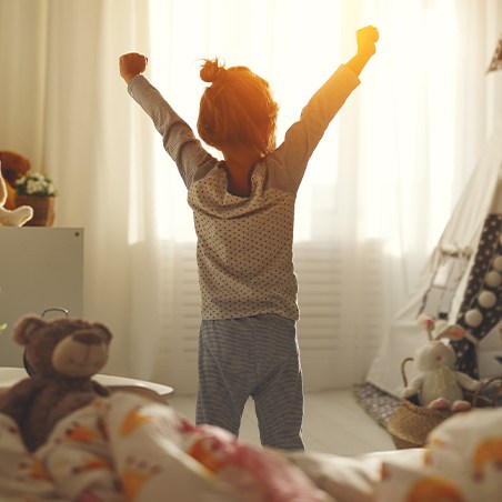 Young girl waking up early before first dental office visit