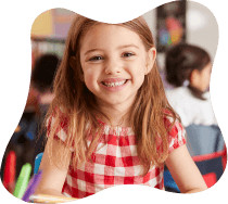 Young girl smiling in classroom