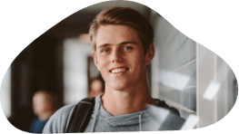 Teenage boy smiling in a school hallway