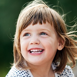 a smiling child outside