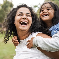 a parent and their child laughing together