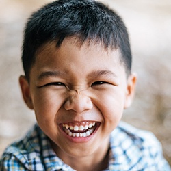 a young boy smiling