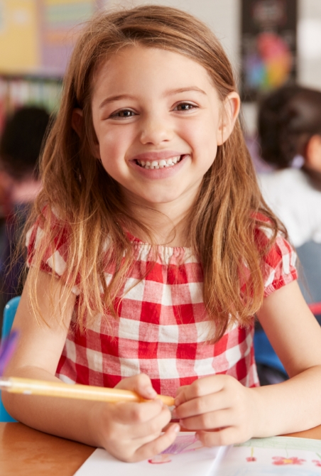 Little girl sharing healthy smile after pediatric dentistry