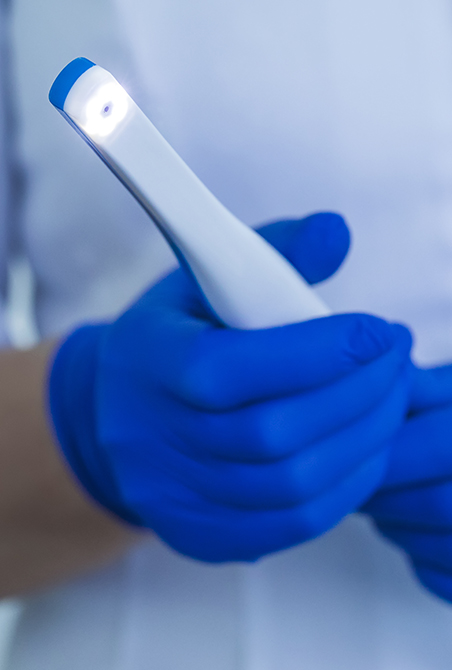 Dental team member holding an intraoral camera