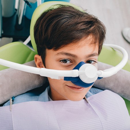 a child with a nose mask on their face to deliver nitrous oxide