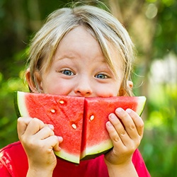 Happy child enjoying watermelon as a healthy snack