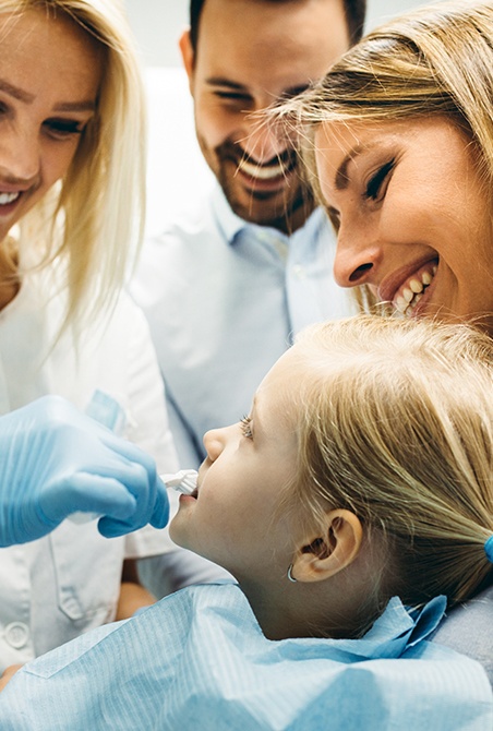 Little girl receiving pediatric dentistry checkup and teeth cleaning