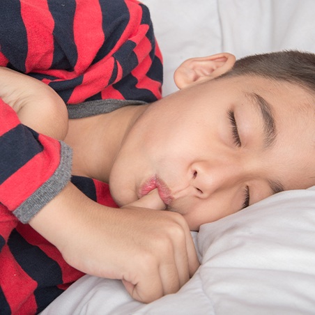 Sleeping child sucking thumb