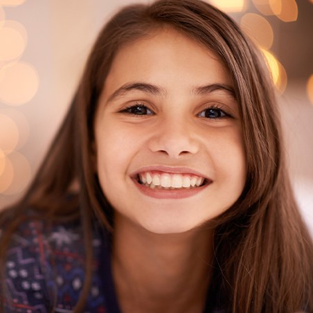 Little girl with tooth colored filling smiling
