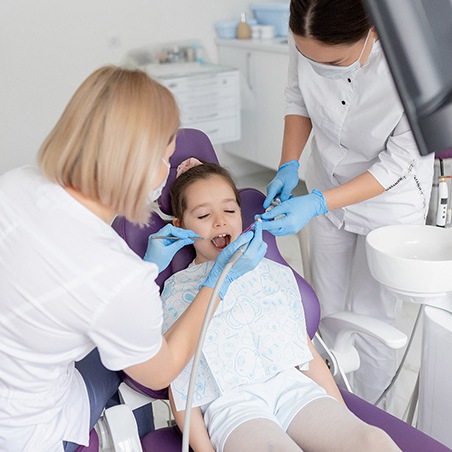 Young girl relaxing during appointment to receive dental sealants