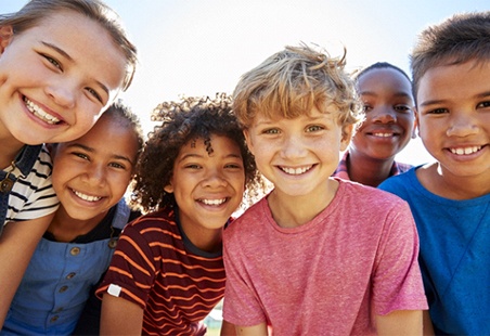 A group of kids all smiling and having fun together in Wylie