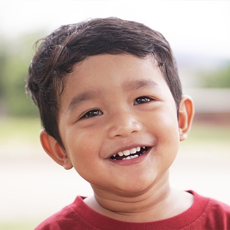Young boy with healthy smile after dentistry for toddlers