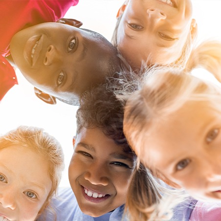 Group of kids with healthy smiles after customized children's dental treatment