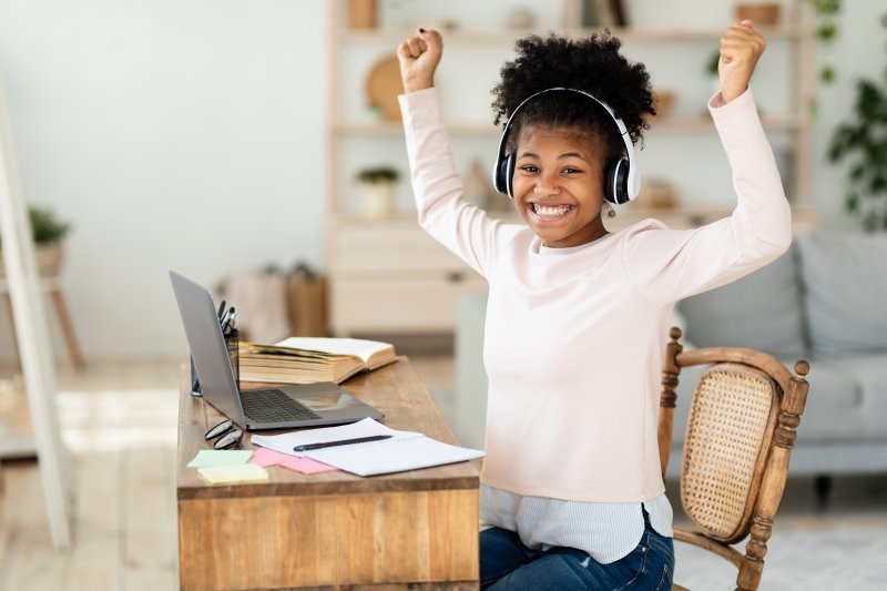 young girl with good oral health and excited about school