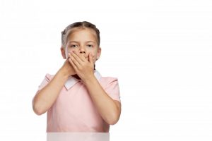 worried girl covering mouth 