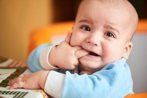 baby showing the signs of teething