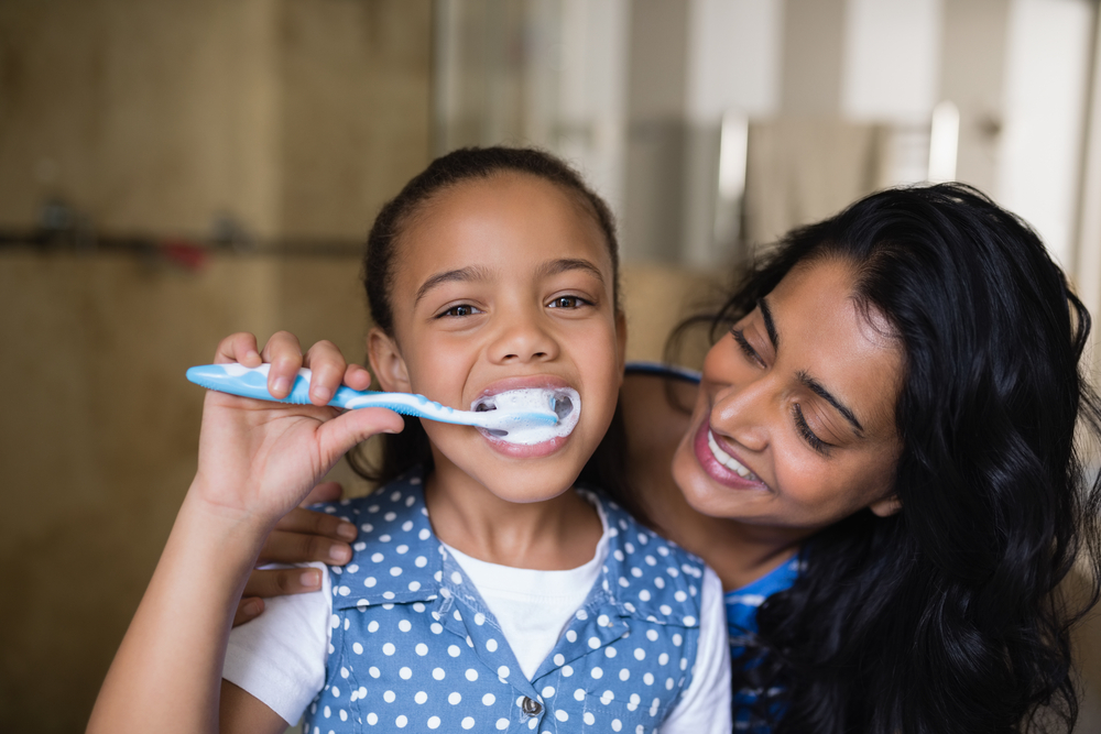 parent and toddler brushing teeth