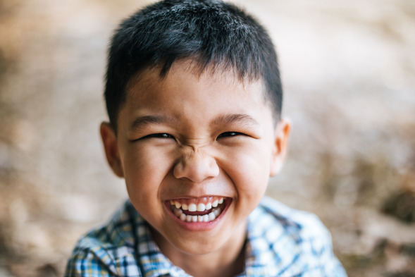 child smiling while visiting dentist