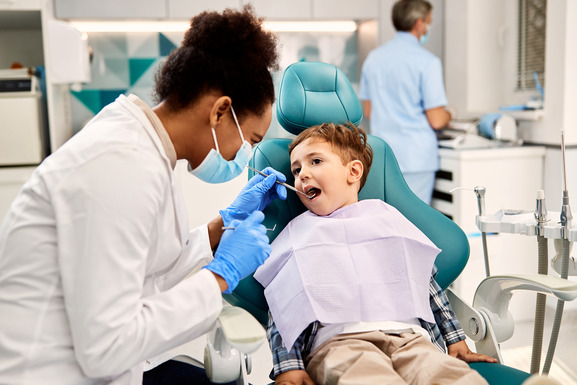 child smiling while visiting cosmetic dentist