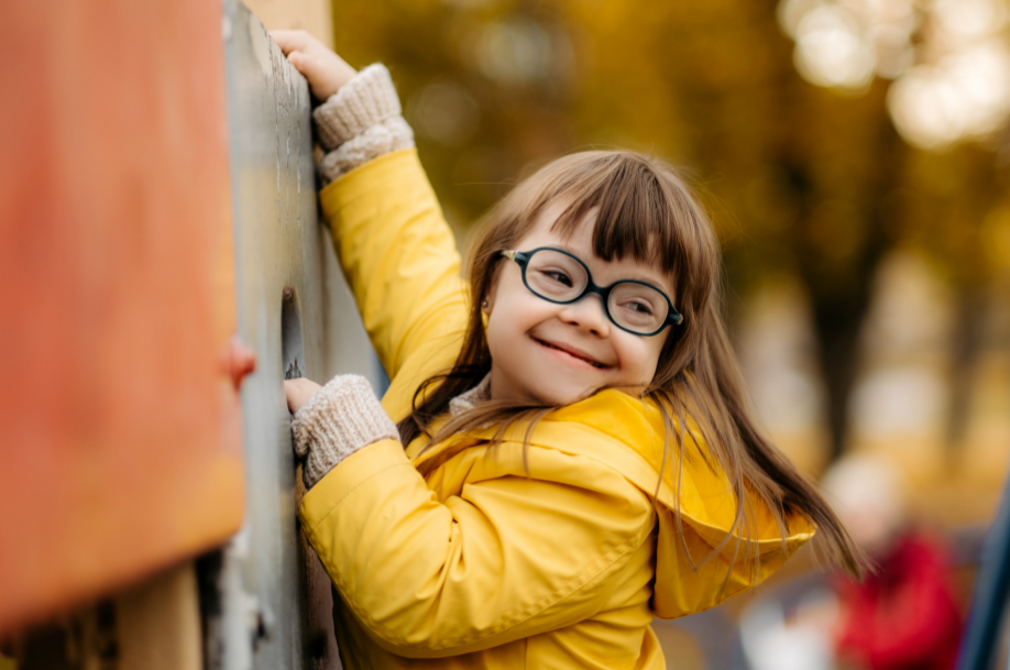 Little girl with downs syndrome on playground